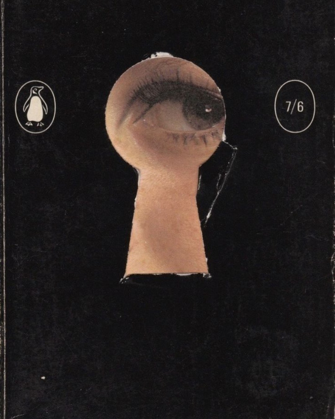 An eye peering through a keyhole